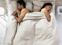 Couple Sleeping on Opposite Sides of Bed