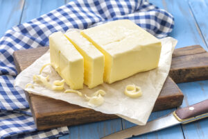 Fresh butter with knife on a chopping board