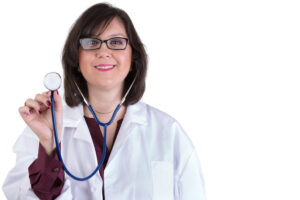 Sympathetic healthcare Intern looking at you genuinely and friendly while holding her stethoscope high