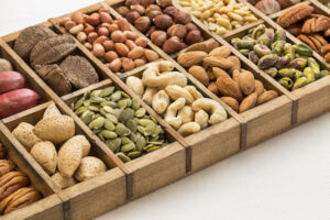 nuts and seed collection (cashew, pecan, pistachio, Brazilian, hazelnut,pine nuts, peanut, pumpkin) in an old typesetter wooden drawer